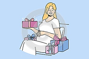 Pregnant woman with gift box strokes belly and looks at screen in anticipation of birth of baby