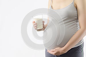Pregnant woman with a glass of milk drink isolated on white back