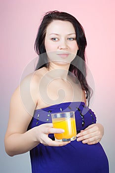 Pregnant woman with a glass of orange juice