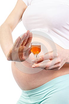 Pregnant woman with glass of wine, concept of unhealthy lifestyles during pregnancy