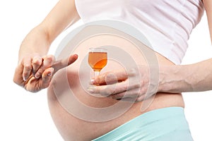 Pregnant woman with glass of wine, concept of unhealthy lifestyles during pregnancy