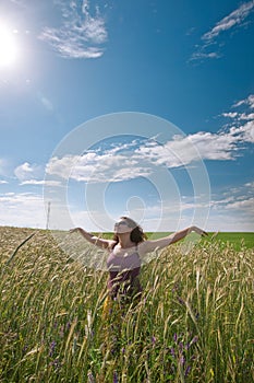 Pregnant woman on green grass field under blue sky