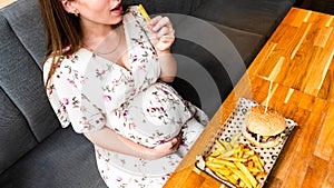 Pregnant woman hamburger eat. Hungry pretty pregnancy female eating tasty burger. Fast food, people and unhealthy eating