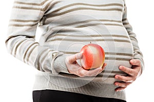 Pregnant woman hand holding red raw ripe apple fruit