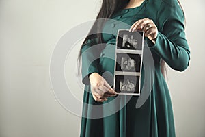 pregnant woman hand ultrasound picture of baby