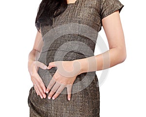 Pregnant woman with hands forming love in the abdomen