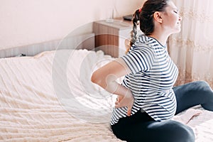 Pregnant woman having back aches, pain