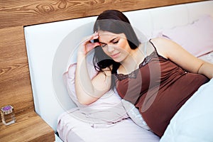 Pregnant woman having a bad headache