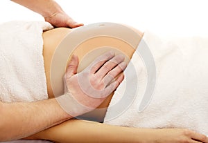 Pregnant woman having a relaxing massage photo