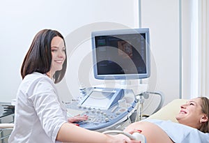 Pregnant woman having ultrasonic scanning at the clinic