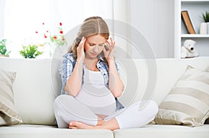 Pregnant woman with headache and pain photo