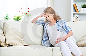 Pregnant woman with headache and pain photo