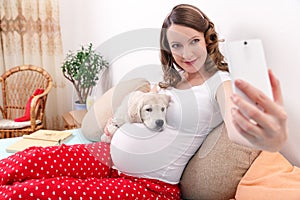 Pregnant woman with her dog at home