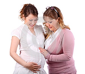 Pregnant woman and her girlfriend touching her stomach