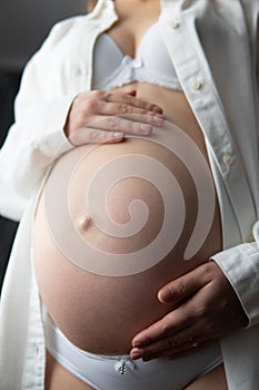 pregnant woman with her hands on her back isolated on white background. Pregnant Woman Holding her Belly.