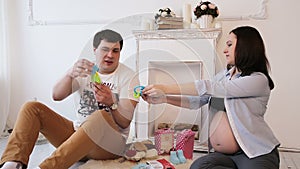 Pregnant woman and her husband and newborn clothing