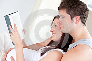 Pregnant woman and her husband reading a book