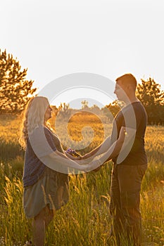 A pregnant woman with her husband is resting in nature