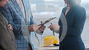 A pregnant woman with her husband signing papers for the apartment rental