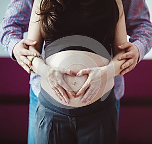 A pregnant woman with her husband waiting for a newborn baby.