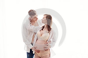 Pregnant woman with her husband on white background