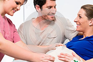 Pregnant woman and her man in delivery room