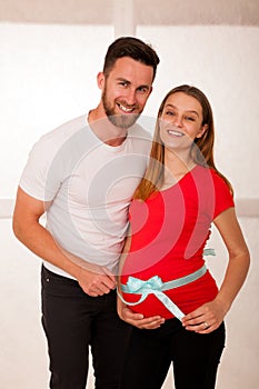 Pregnant woman and her man - studo photography of a young couple