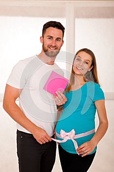 Pregnant woman and her man - studo photography of a young couple photo
