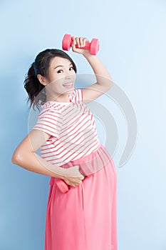 Pregnant woman hold dumbell