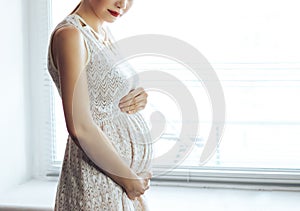 Pregnant woman hold her bell