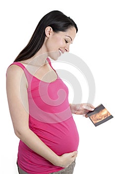 Pregnant woman holding 4d scan photo
