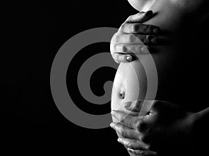 Pregnant woman holding abdomen