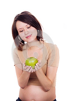 Pregnant woman holding an apple in her hands