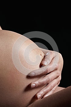 Pregnant woman holding baby bump