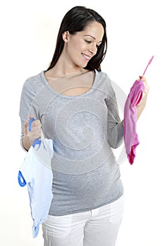 Pregnant woman holding baby clothes