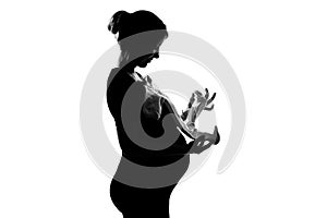 Pregnant woman holding baby clothes