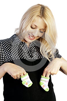 Pregnant woman holding baby's socks