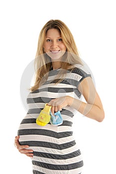 Pregnant woman holding baby shoes