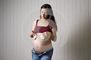 Pregnant woman holding baby socks