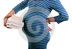 Pregnant woman holding books of pregnancy