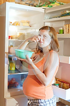 Pregnant woman holding foul food