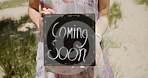 Pregnant woman holding frame chalkboard coming soon, woman holding frame chalkboard coming soon