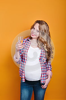 Pregnant woman holding glass of water . Pregnan concept: healthy nutrition during pregnancy.