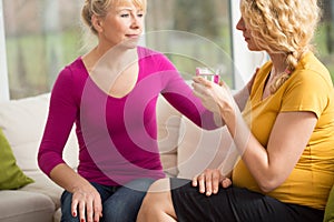 Pregnant woman holding glass of water