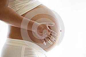 Pregnant woman holding her belly