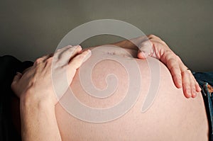 Pregnant woman holding her bump