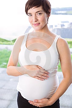 Pregnant woman holding her bump