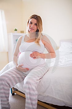 Pregnant woman holding her bump