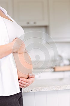 Pregnant woman holding her bump