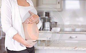 Pregnant woman holding her bump